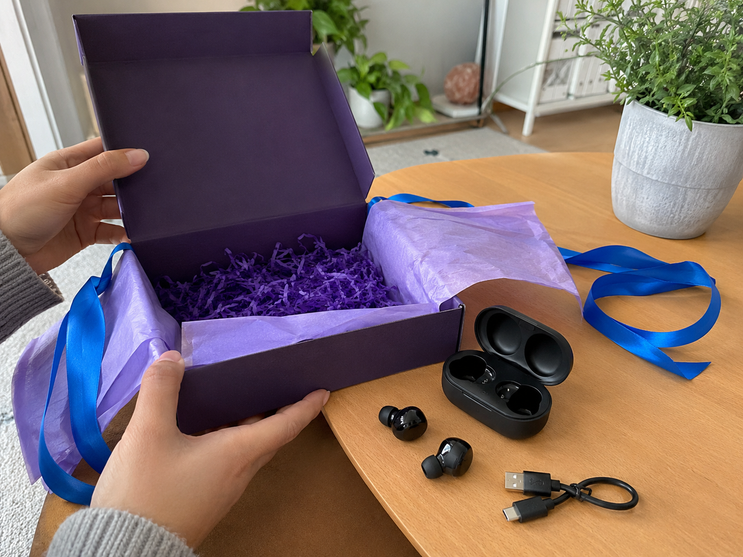 Illustrative purple box unboxing with wireless earbuds